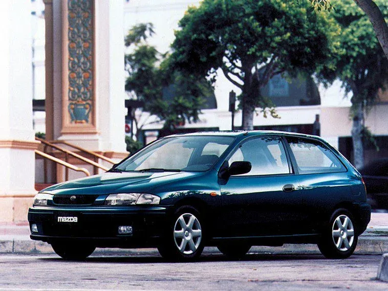 Логотип Mazda 323 Хэтчбек 3 дв. 6 (BJ)