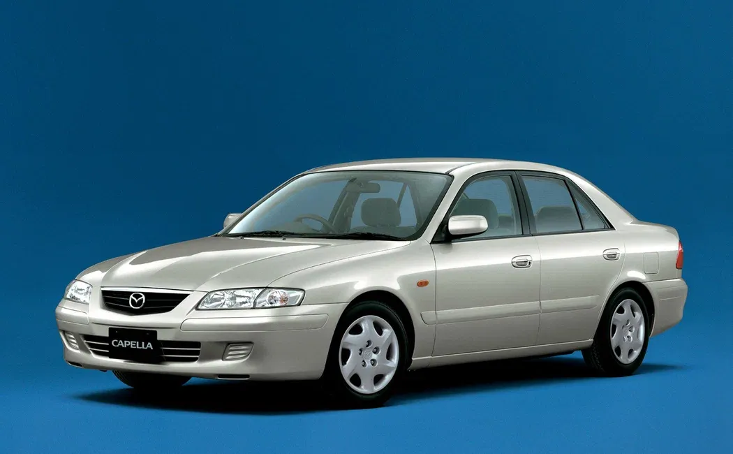 Логотип Mazda Capella Седан 4 дв. 6 поколение